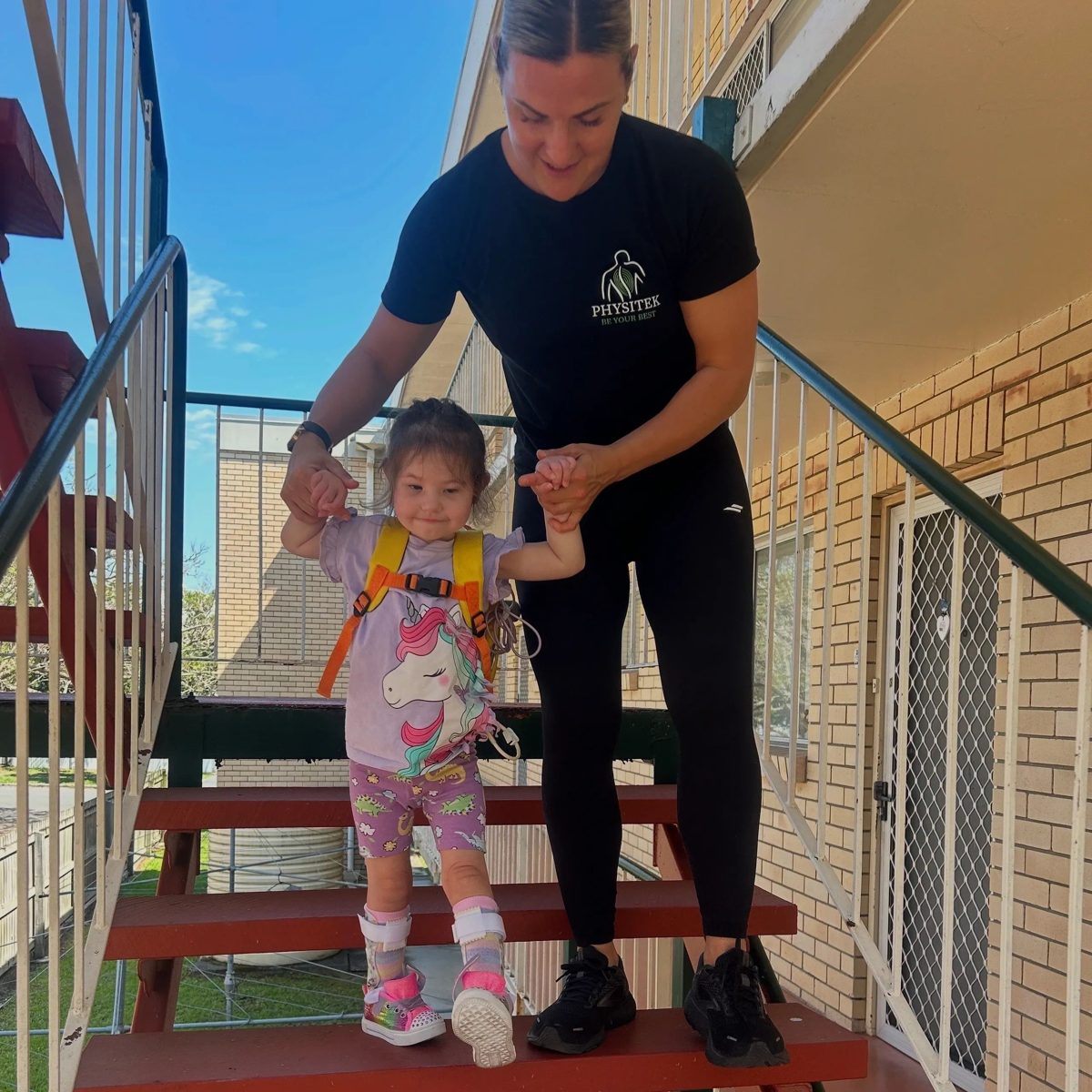 Physiotherapist supporting a baby during tummy time